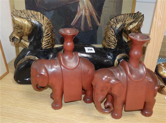 A Chinese carved wood horse group and a pair of lacquered elephant candlesticks